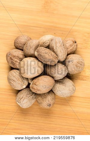 Pile Of Whole Dried Nutmeg Seed For Flavoring