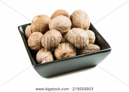 Pile Of Whole Dried Nutmeg Seed For Flavoring
