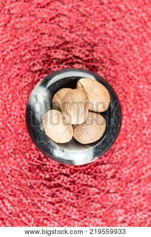 Pile Of Whole Dried Nutmeg Seed For Flavoring