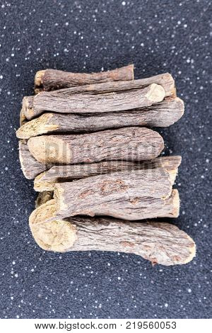 Pile Of Licorice Root On A Black Background