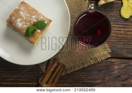 homemade pie with tea on a wooden background