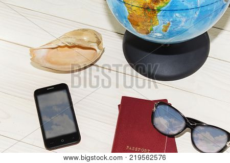 Concept photo of tourist planing the trip with map, passport, mobile phone
