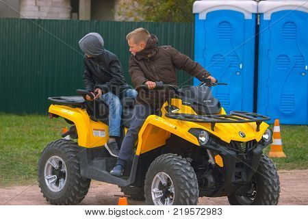 Zhytomyr, Ukraine - September 29, 2017: two teenagers on a quad bike turned back and watched interested