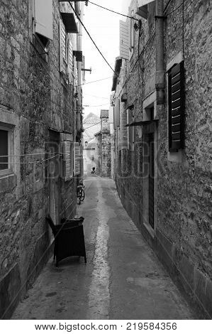 Old narrow stone street inside Milna old town, Croatia.