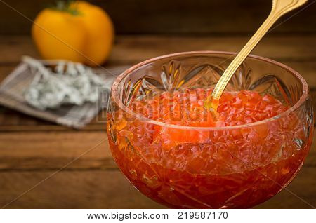 Red caviar in glass jar with gold spoon close up. Sea food. Healthy eating. Diet. Wooden rustic background. Top view. Selective focus
