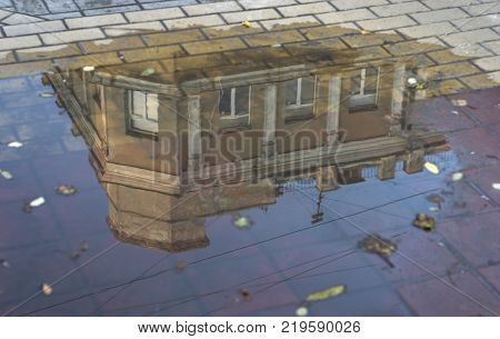In reflection of building in puddle HD