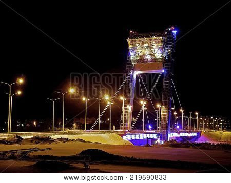 Bridge illuminated at night. The bridge in Salekhard