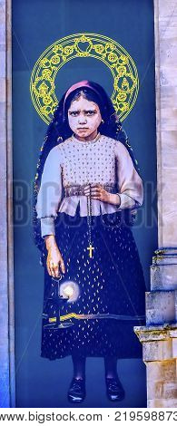 FATIMA, PORTUGAL - SEPTEMBER 17, 2017 Jacinta Banner 100th Celebration Mary's Appearance Basilica of Lady of Rosary Bell Tower Fatima Portugal. Site where Jacinta and two Portuguese Shepherd children saw Virgin Mary.