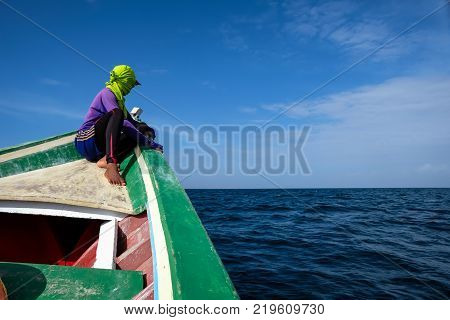 Hooded sailor man looking at the sea horizon (Margarita island, Venezuela).
