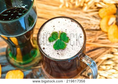 Mug of light beer and green Irish beer close-up in Patrick's Day