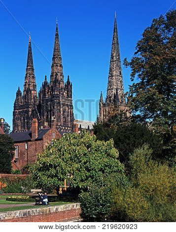 LICHFIELD, UNITED KINGDOM - JULY 20, 1994 - Cathedral Church of the Blessed Virgin Mary and St Chad with gardens of remembrance in the foreground Lichfield Staffordshire England UK Western Europe, July 20, 1994.