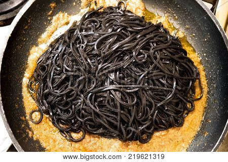 black pasta squid ink pan up view italian taglierini al nero di seppia.