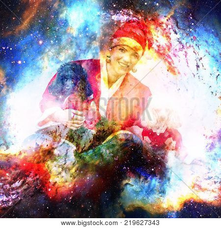 Cheerful young woman in christmas outfit accompanied by two sweet poodles in cosmic space