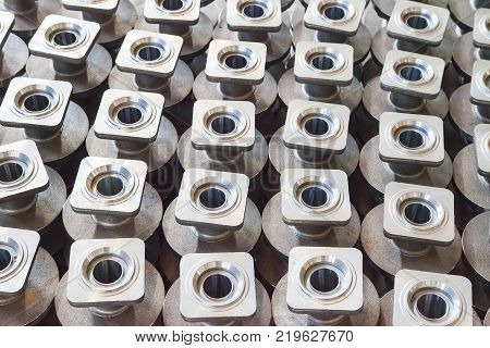 Heap of valve bodies spare parts prapared for mashining in factory. Casting carbon steel boides. Forging stainless still parts. Industrial background from part of valves for power, oil or gas industry