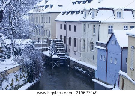 Czech Republic - Prague -  Water mill nearest Charles Bridge in winter morning during snowfall