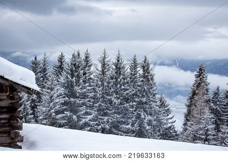 snowy and foggy montain wooden cabin landscape