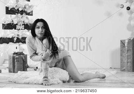 Beautiful Brunette on the Background of New Year's decoration. Fashion Beauty Portrait. Sexy Girl. Holiday Makeup.