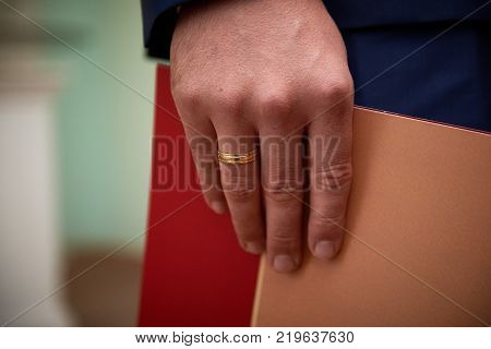 Close-up image of hand of groom with wedding ring on it
