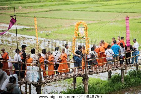 Lampang, Thailand - July 9, 2017: Unidentified People Offer Food To Monks In Devo Tradition On July