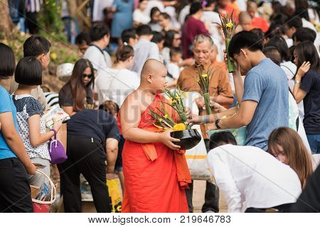 Lampang, Thailand - July 9, 2017: Unidentified People Offer Food To Monks In Devo Tradition On July