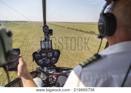 View from helicopter cockpit Robinson R44 during flying