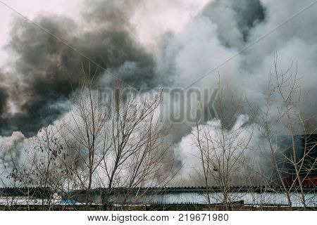 Fire in an industrial warehouse or Factory on Lantenskaya Street in Voronezh, rubber is burning, lots of smoke and flames, firefighters and MES rescue workers are struggling with a fire