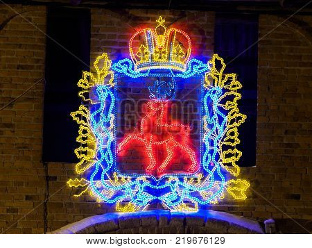 winter night view of coat of arms of Nizhny Novgorod on the Kremlin wall