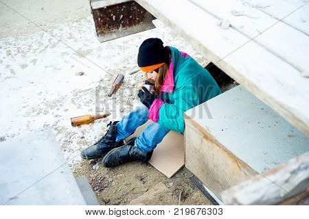 A portrait of a homeless hungry woman