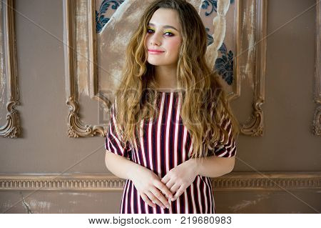 A portrait of a teen girl model in a stdio