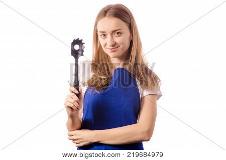 Young woman in apron holding spaghetti spatula on a white background isolation