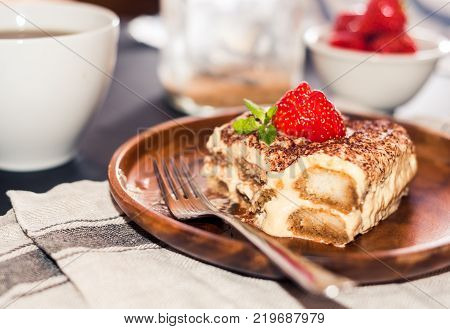 Homemade tiramisu cake decorated with strawberries Italian cuisine,