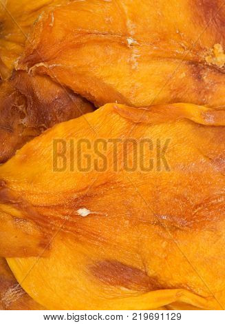 Unsweetened and unsulfured organic dried mango in wooden bowl