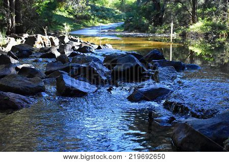 A rocky waterfall along a river crossing
