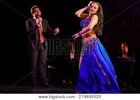 MOSCOW, RUSSIA - OCT 21, 2017: Bellydancer, Yasser Alama and orchestra on stage of Luna Theatre during Gala Concert after 12th international festival of oriental dance ASSEMBLY 2017.