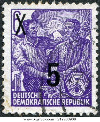 DDR - CIRCA 1953: A stamp printed in DDR shows the German and Soviet workers shake hands (overprint 1954) circa 1953