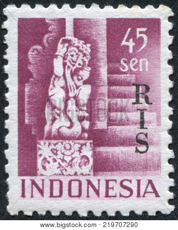 INDONESIA - CIRCA 1950: A stamp printed in the Indonesia shows the sculpture of the god Shiva from Temple at Bedjoening Bali. Overprint RIS (Netherlands Indies) circa 1950
