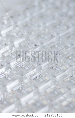 Abstract high-tech background. A sheet of transparent plastic or glass with the cut out holes. Laser cutting of plexiglass.