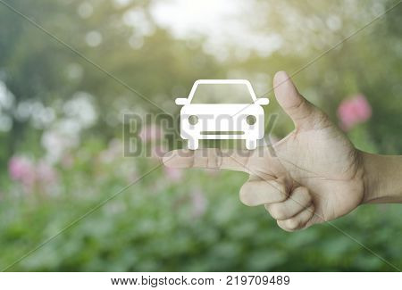 Taxi car flat icon on finger over blur pink flower and tree Business service car concept