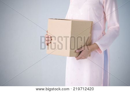 beautiful woman in pink dress and vietnam hat holding box