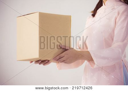 Beautiful Woman In Pink Dress And Vietnam Hat Holding Box