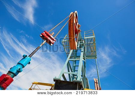 Pumpjack.
A pumpjack is the overground drive for a reciprocating piston pump in an oil well.
The arrangement is commonly used for onshore wells producing little oil. Pumpjacks are common in oil-rich areas.
