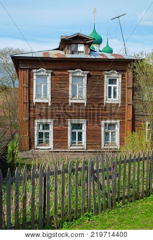 Old rustic wooden house with two floors in the springtime