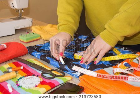 Close-up of woman's hand stitching quilting. Tailor Woman working in his tailor shop Tailoring. Garment industry tailoring concept