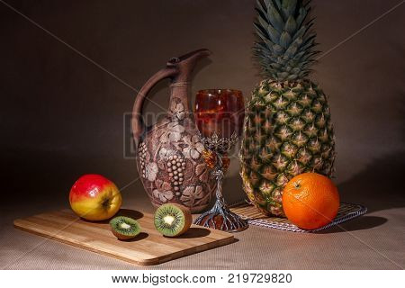 Tropical fruit and a jug on the table display.