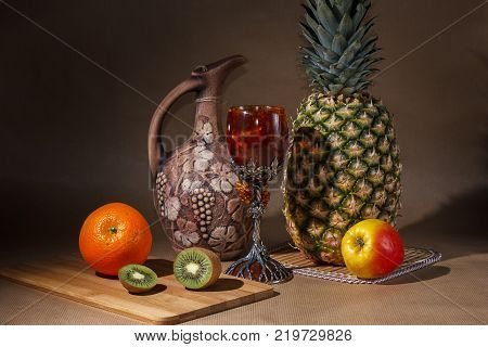 Tropical fruit and a jug on the table display.