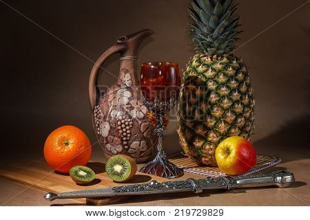 Tropical fruit and a jug on the table display.