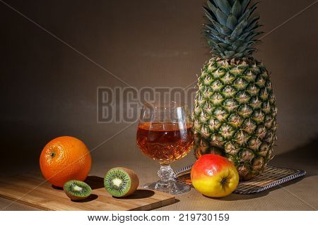 Tropical fruit and a jug on the table display.