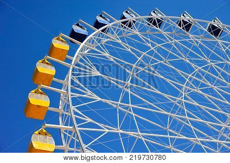 Ferris wheel at Issyk-Kul.
A Ferris wheel is a nonbuilding structure consisting of a rotating upright wheel with multiple passenger-carrying components.