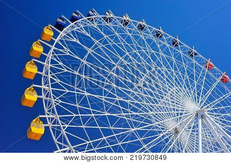Ferris wheel at Issyk-Kul.
A Ferris wheel is a nonbuilding structure consisting of a rotating upright wheel with multiple passenger-carrying components.