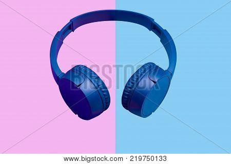 Wiireless headphones on vivid color background. Flat minimal style. Design and colors